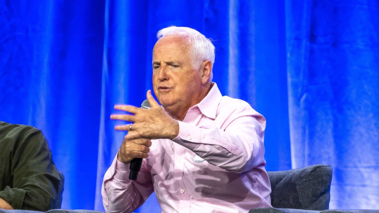 Tom Fitzgerald speaking onstage at a Disney event