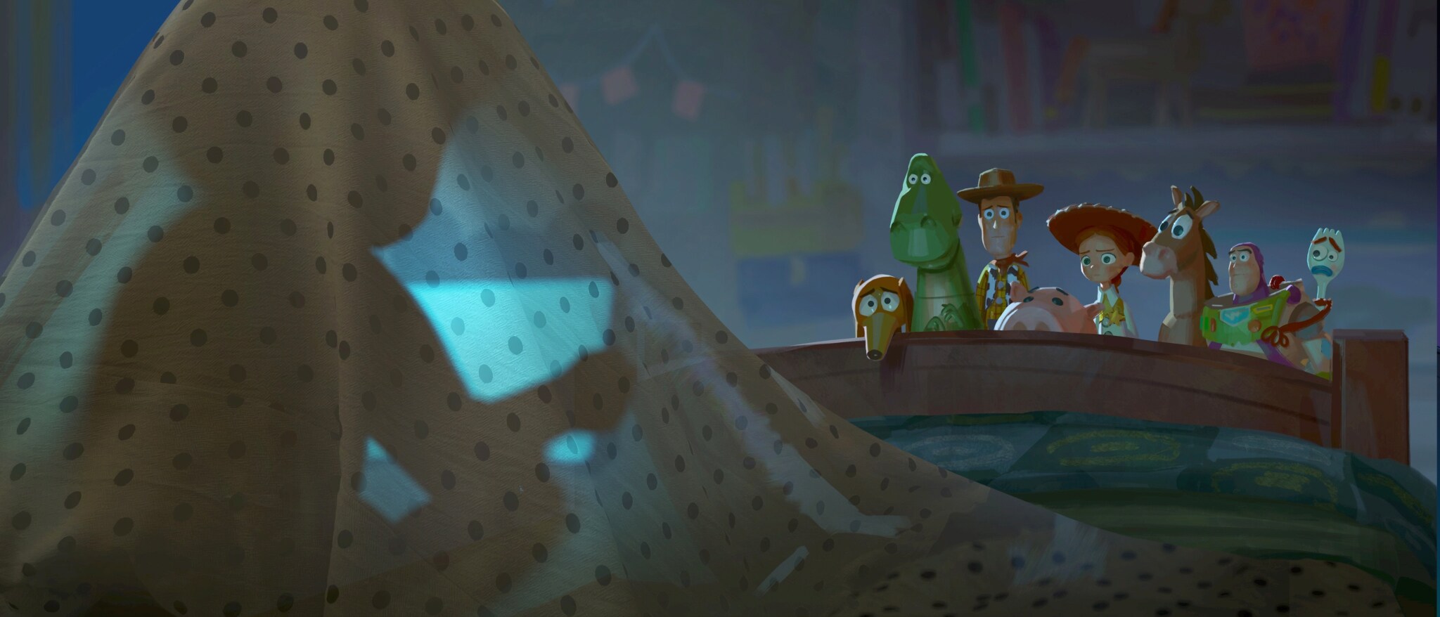 Woody, Buzz Lightyear, Jessie and other Toy Story 5 characters watch a tablet from behind a blanket fort
