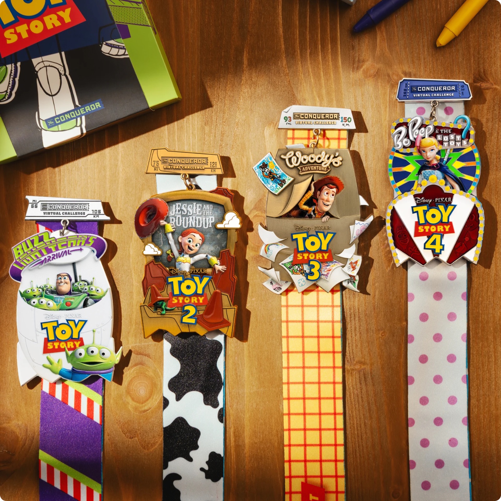 Four Toy Story medals displayed with Woody, Buzz Lightyear, Jessie and Bo Peep artwork