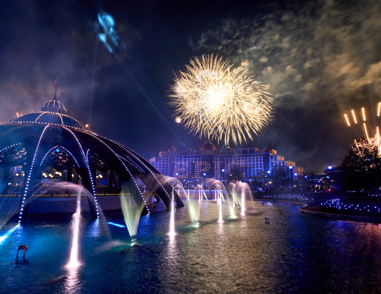 Universal Epic Universe nighttime celebration with the park carousel and fireworks