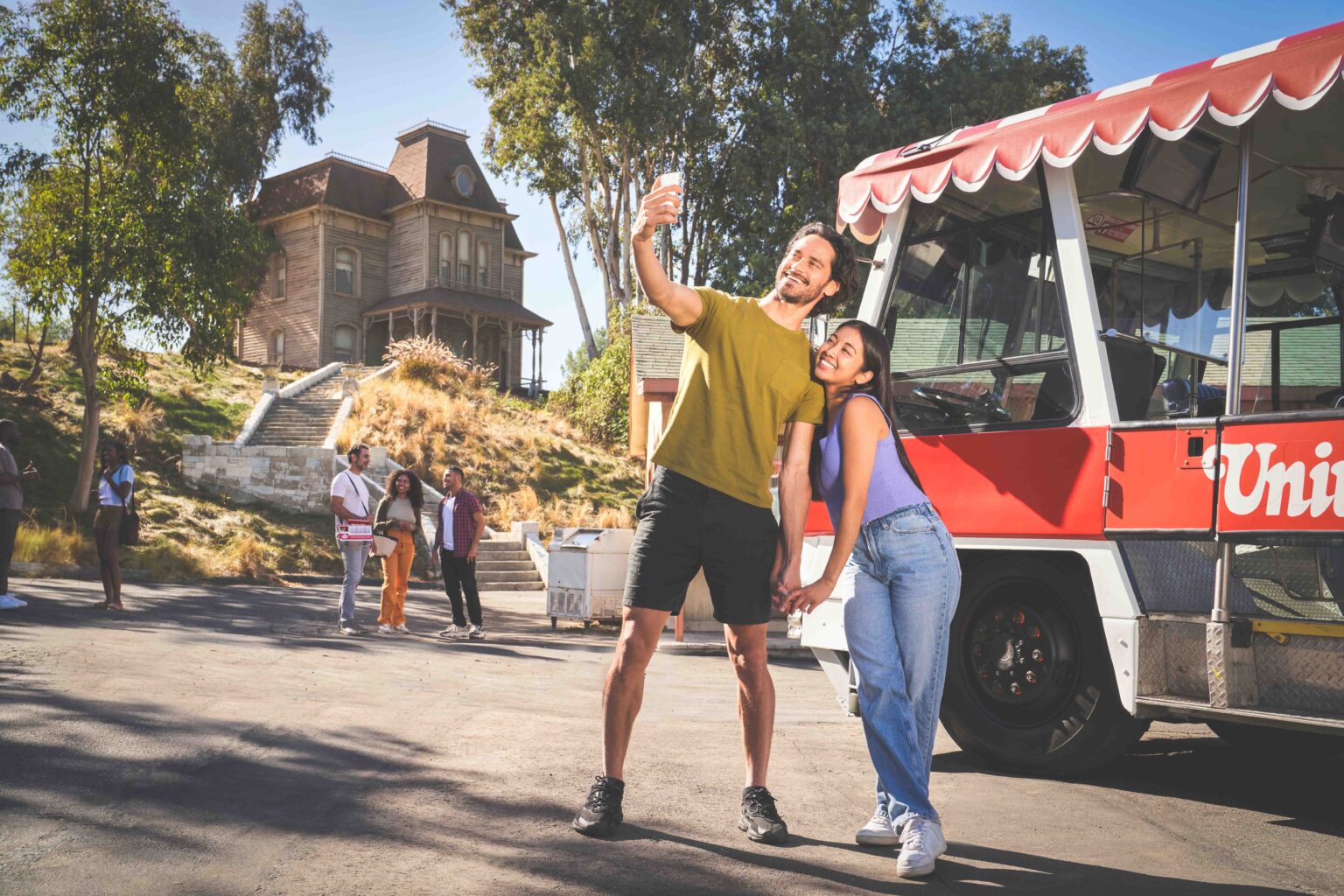 Guests aboard a Universal Studios Hollywood Studio Tour tram beside the Psycho House set