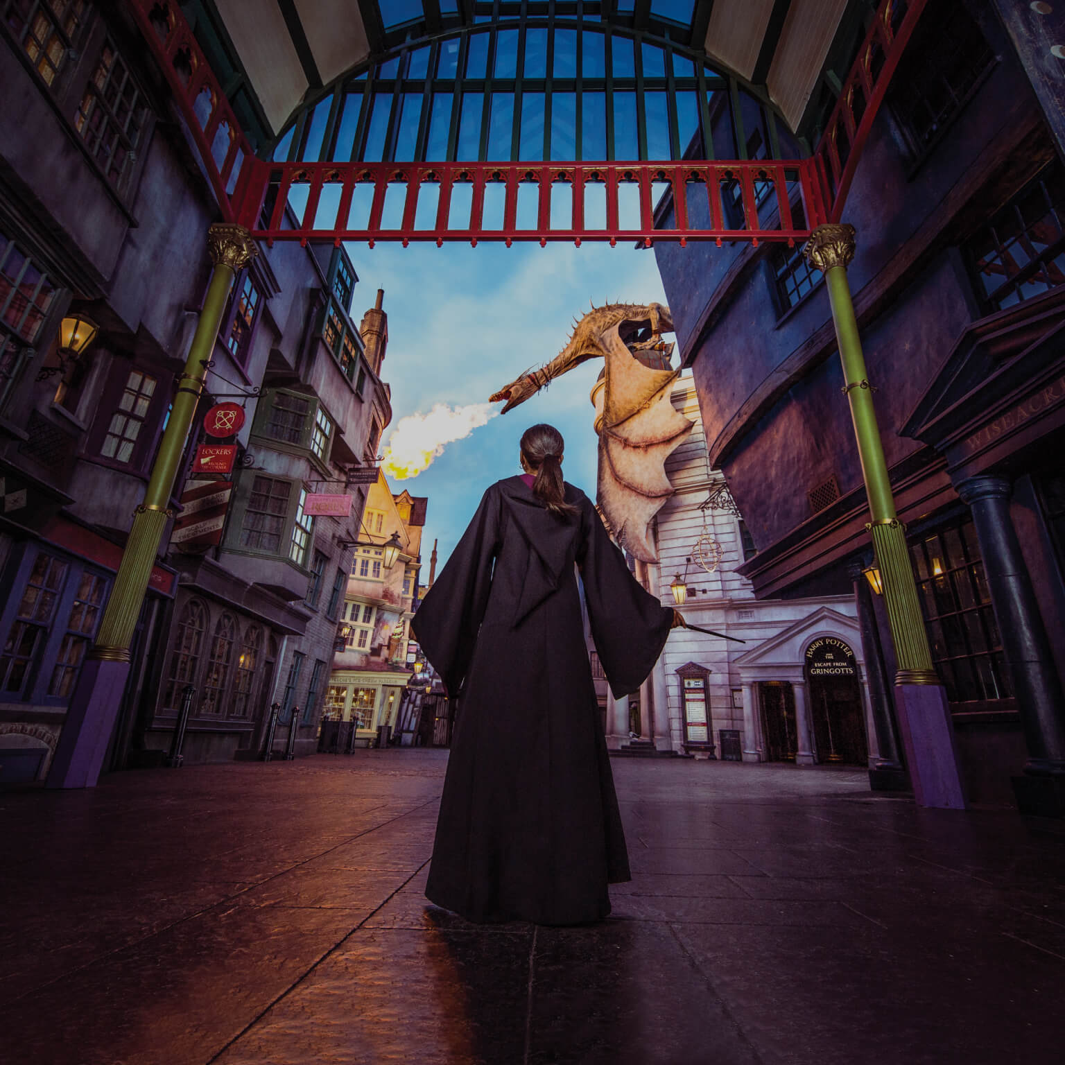 A guest standing beneath the dragon in Diagon Alley at Universal Orlando