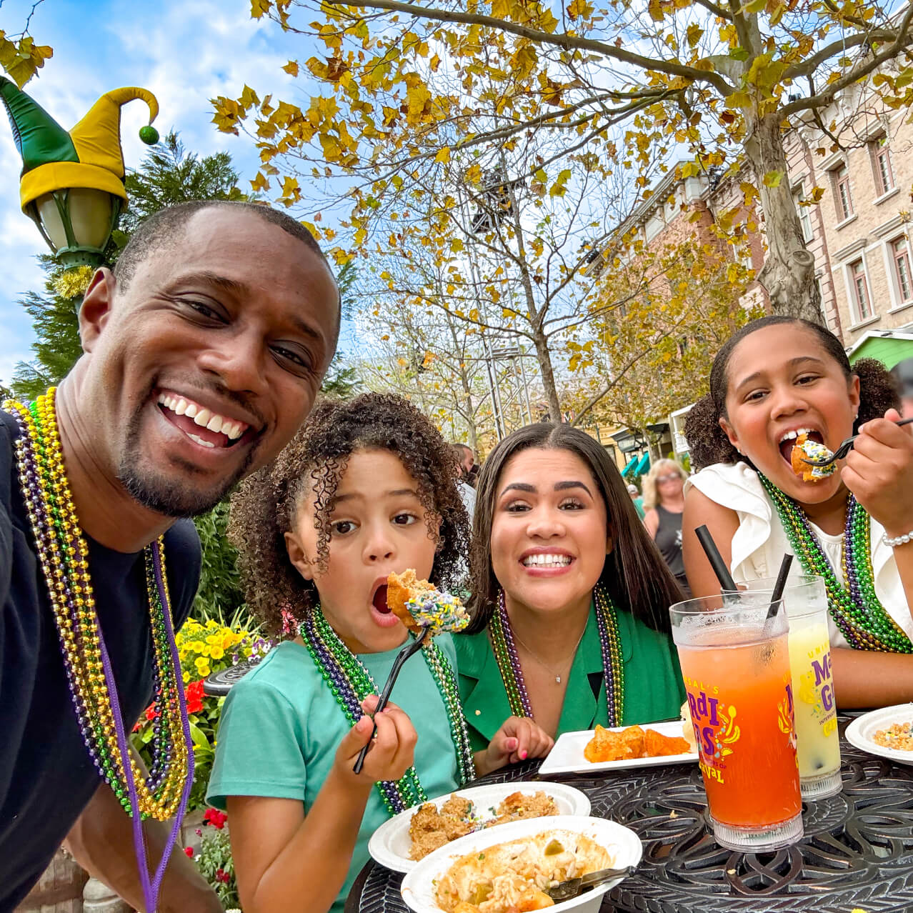 A Universal Orlando Passholder family sharing food during Mardi Gras