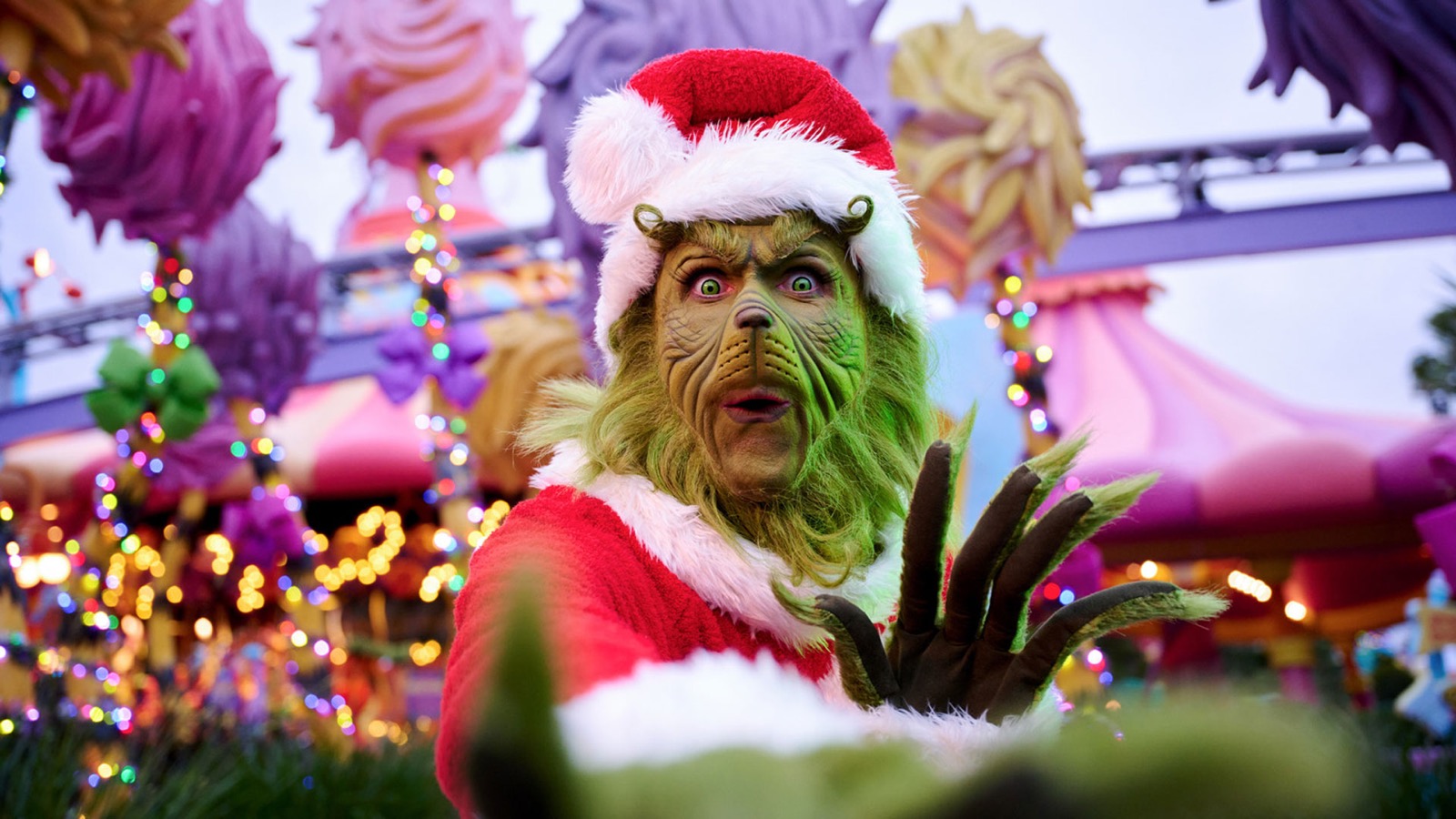 The Grinch wearing a Santa suit during Grinchmas