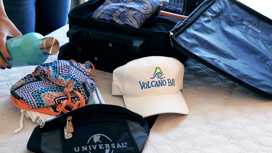 A water bottle and Universal Orlando park gear being packed for a visit