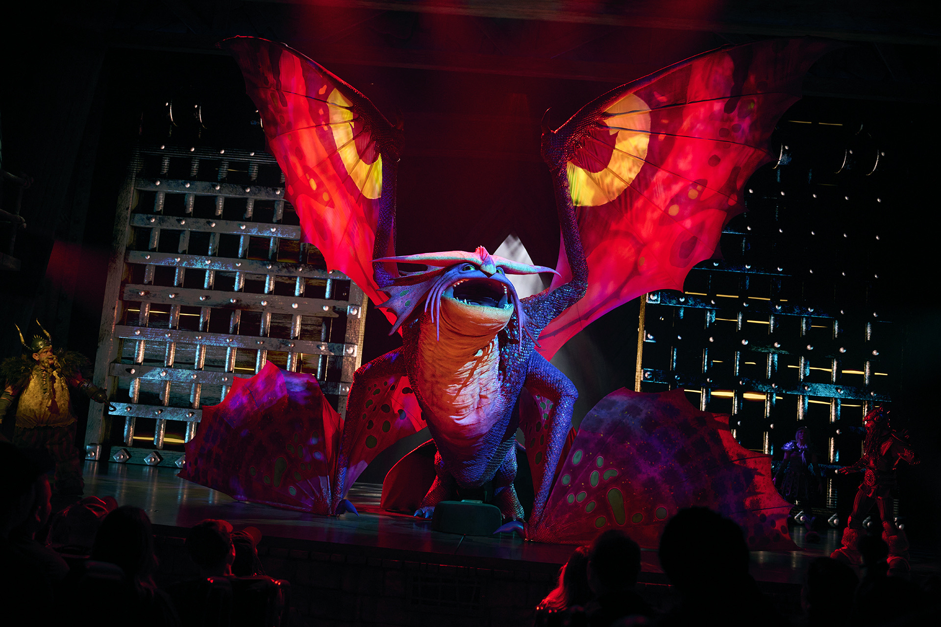 A large dragon puppet performs in The Untrainable Dragon at Epic Universe