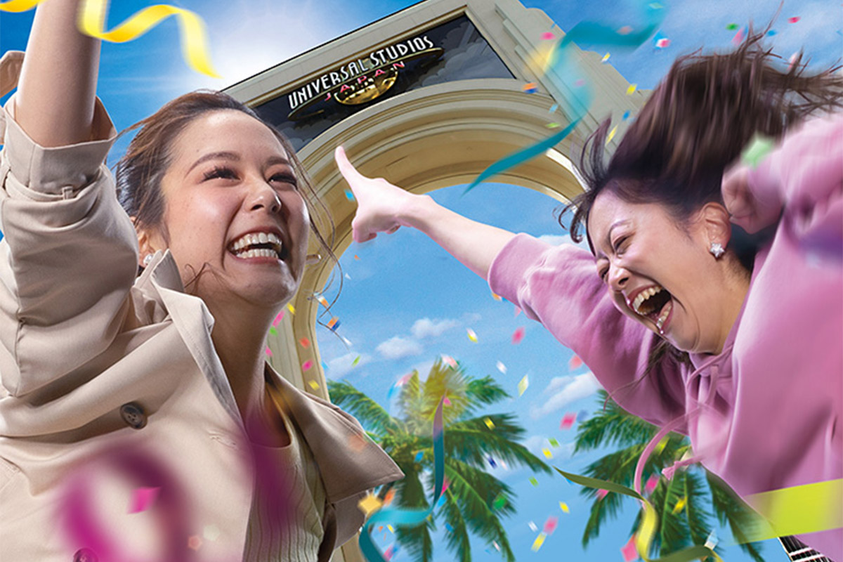 Two guests celebrate outside the Universal Studios Japan front gate in annual pass benefit artwork