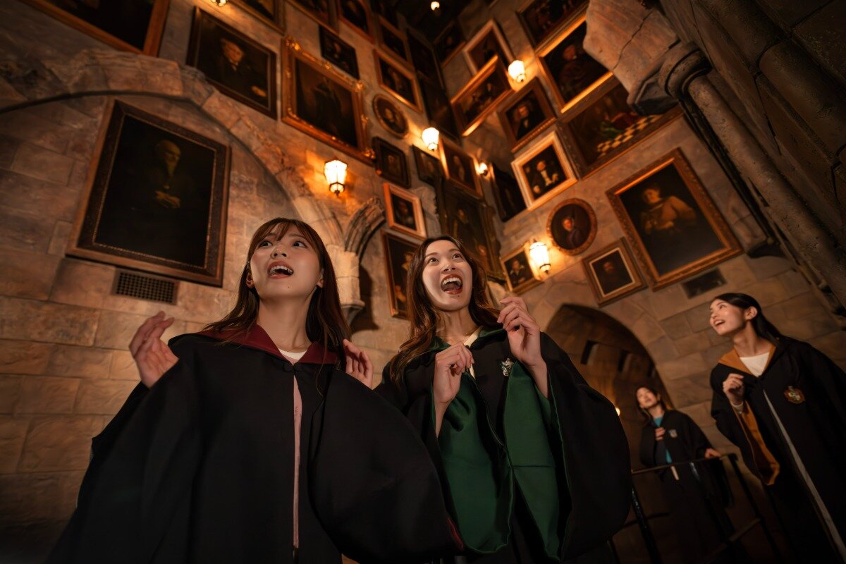 Guests view talking portraits inside Hogwarts Castle at Universal Studios Japan