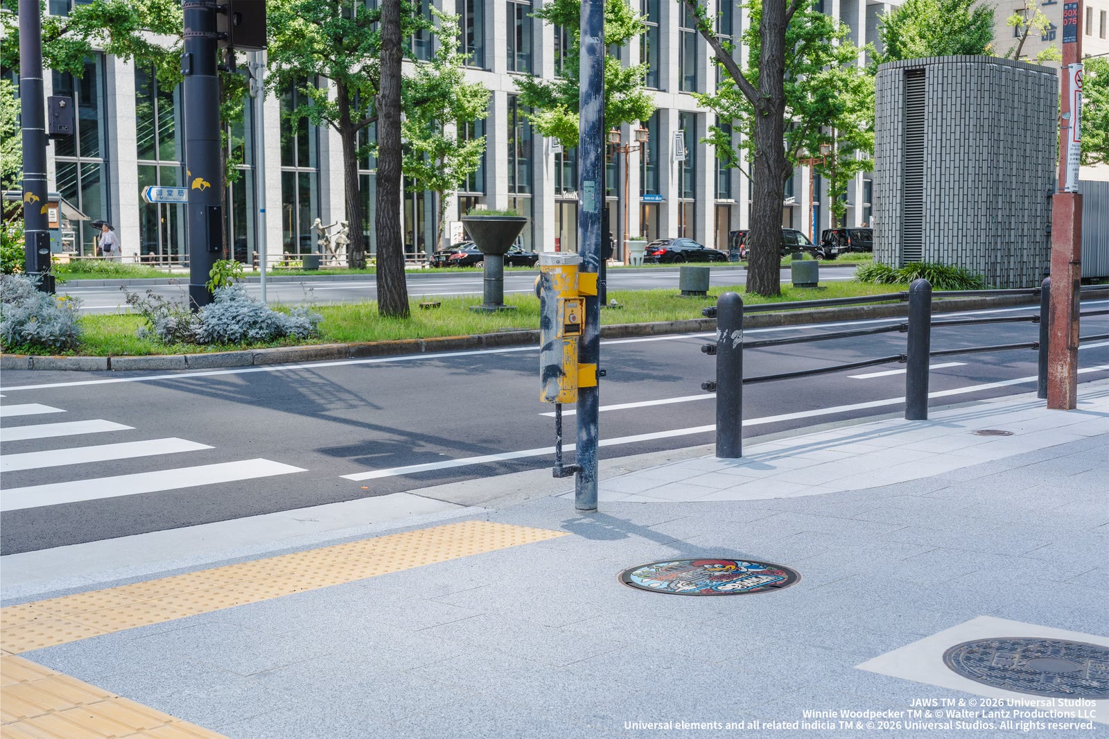 Universal Studios Japan anniversary manhole cover installed along Midosuji in central Osaka