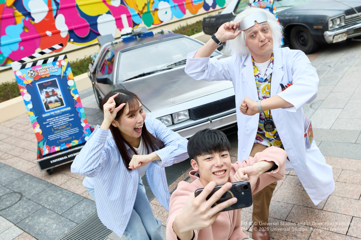 Doc Brown poses with guests and a DeLorean at Universal Studios Japan