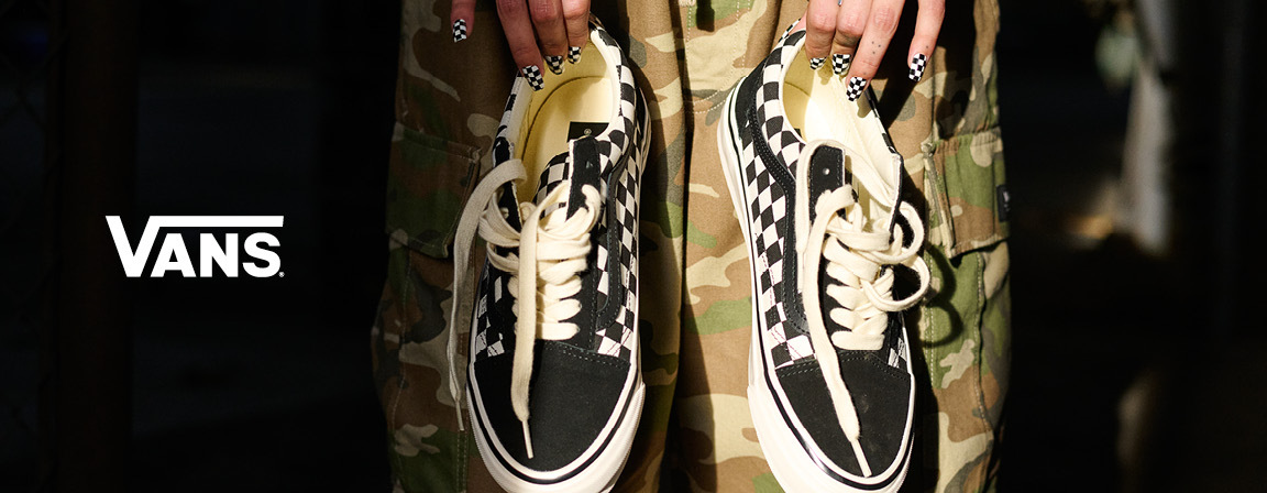 Vans checkerboard shoes and logo from the official Vans Disney Springs store page