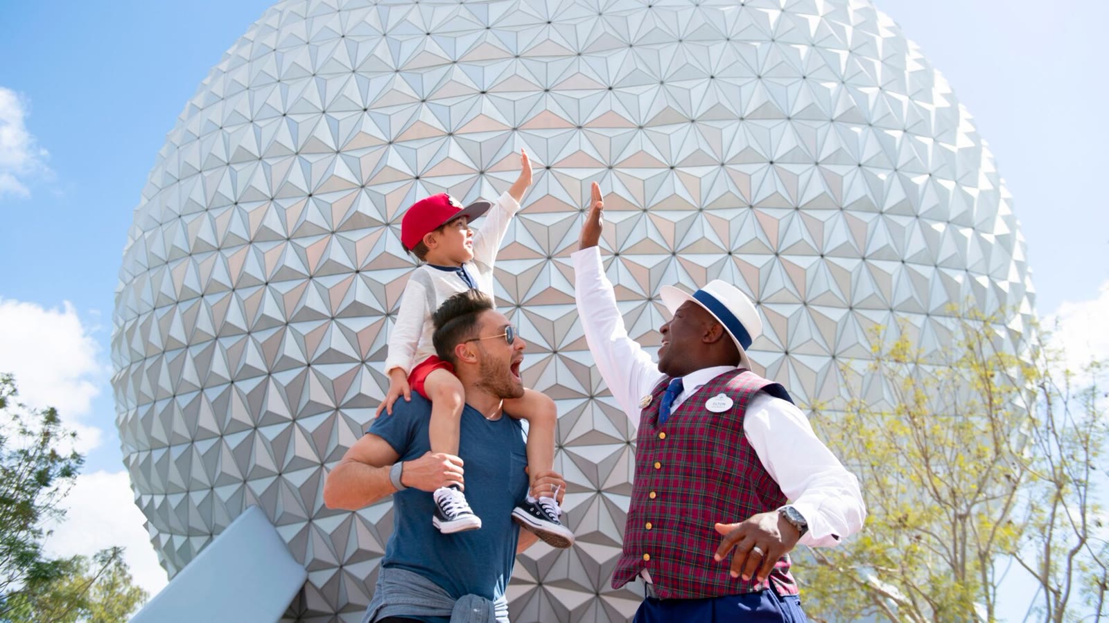 Walt Disney World VIP Tour Guide greeting a family in front of Spaceship Earth